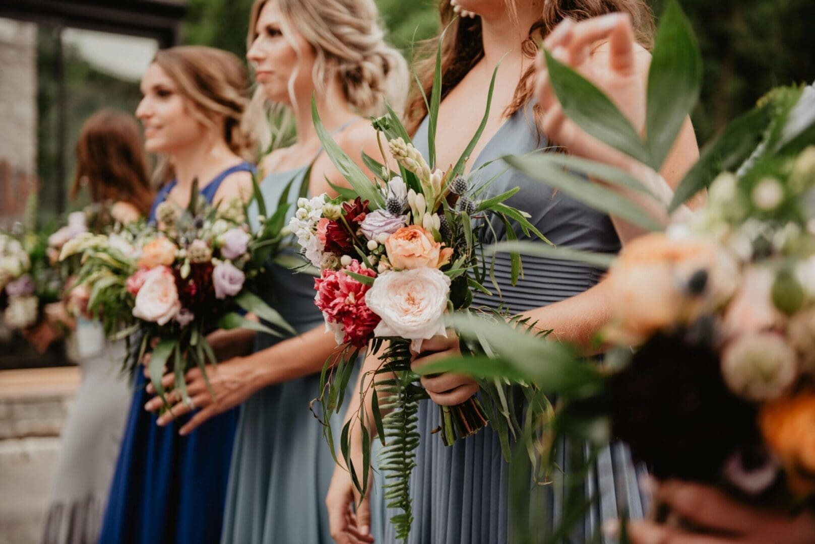 A group of women holding flowers in their hands.