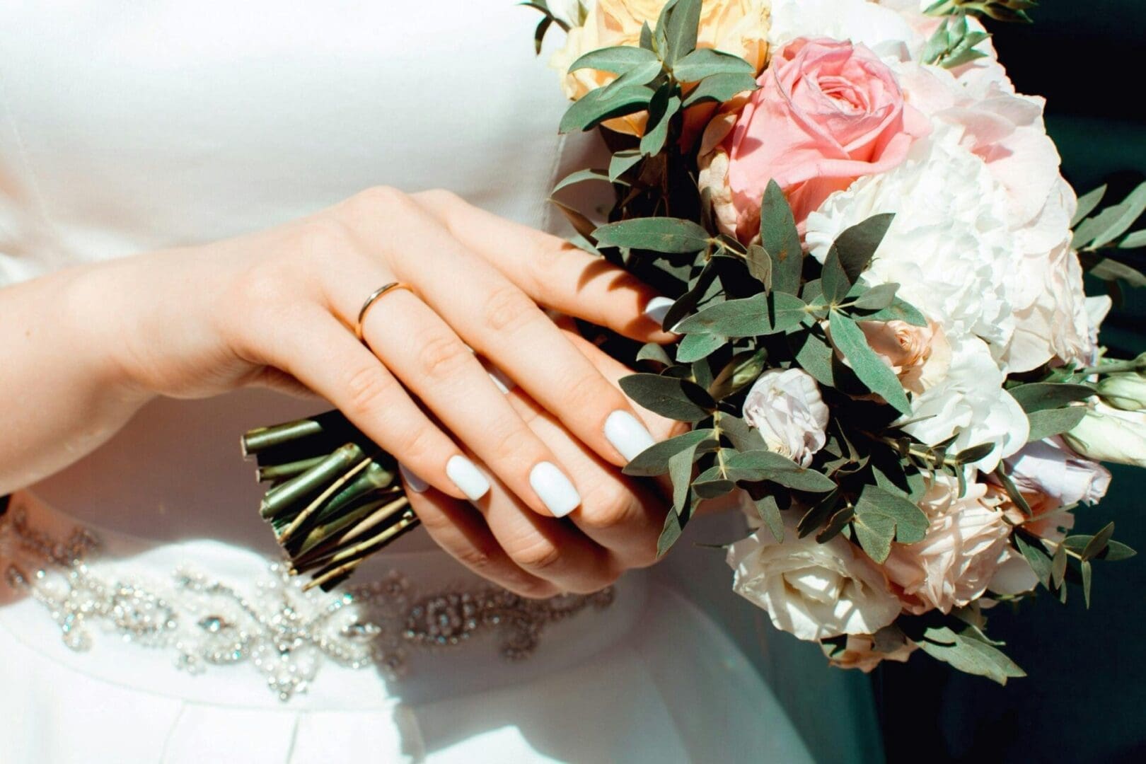 A close up of two hands with wedding rings on